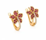 Gold-tone butterfly-shaped earrings with pink stones and a diamond-studded stem, shown in pairs against a white background to emphasize their ornate design.