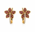 Pair of gold flower-shaped earrings with purple gemstones and a diamond-studded stem.