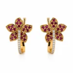 Pair of gold flower-shaped earrings with purple gemstones and a diamond-studded stem.
