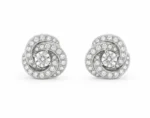 Pair of spiral diamond stud earrings with a central round diamond and pavé-set diamonds along the spirals, in white metal.