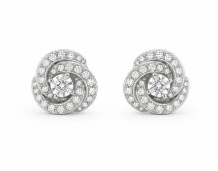 Pair of spiral diamond stud earrings with a central round diamond and pavé-set diamonds along the spirals, in white metal.