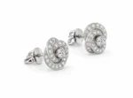 Diamond stud earrings with circular halo of small diamonds and a larger center stone on a white background, showing front view and backs.
