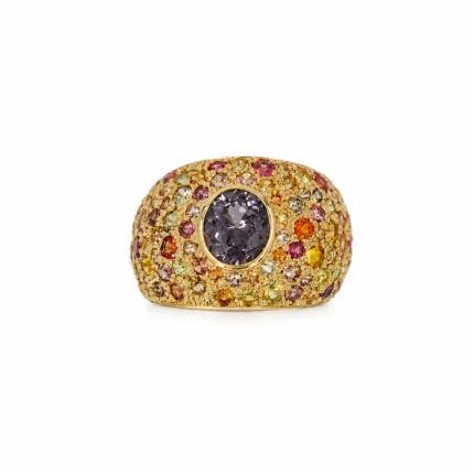 Gold ring covered with multicolored gems and a large round dark purple center stone.