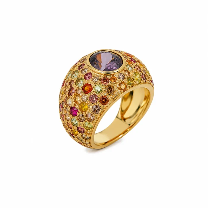 Gold ring covered in multicolored gemstones with a large purple centerpiece stone in a raised setting.